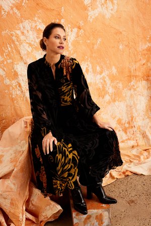 The image shows a woman wearing the Kamare premium Burntout Velvet dress called Tangiers, offering both comfort and flexibility. The dress is perfect for events, Autumn evenings, luncheons and weekend getaways.