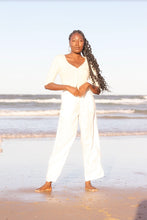 Load image into Gallery viewer, Lilly Pilly Jade Cashmere Cardigan in Ivory worn by woman on Byron Bay beach
