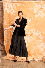 Load image into Gallery viewer, Image shows a woman wearing the CRUSHED SILK MAXI SKIRT-from Kamare brand in Black Creativity designed with gorgeous features you will be sure to turn heads when you head out in this masterpiece. Its midi length, has a full skirt is lined and made of 100% crushed silk
