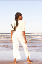 Load image into Gallery viewer, Lilly Pilly Jade Cashmere Cardigan in Ivory worn by woman on Byron Bay beach

